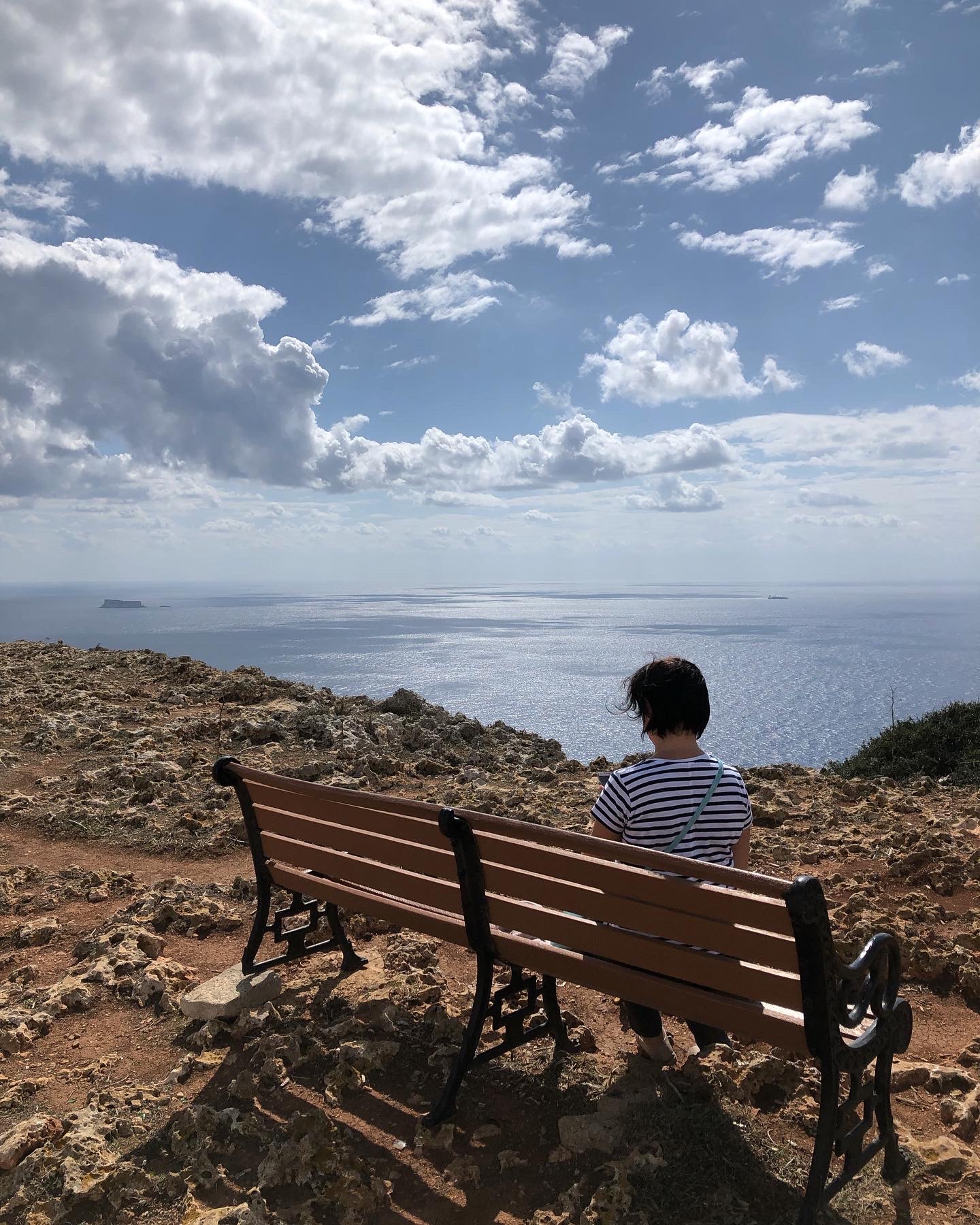 woman sitting by the sea